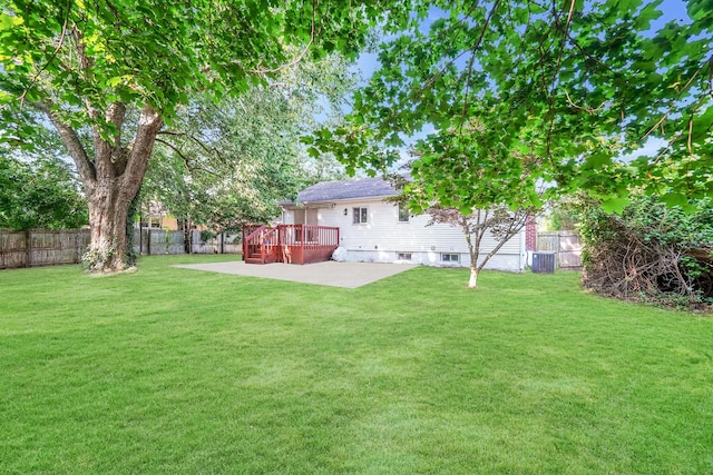 view of yard featuring a patio and a wooden deck