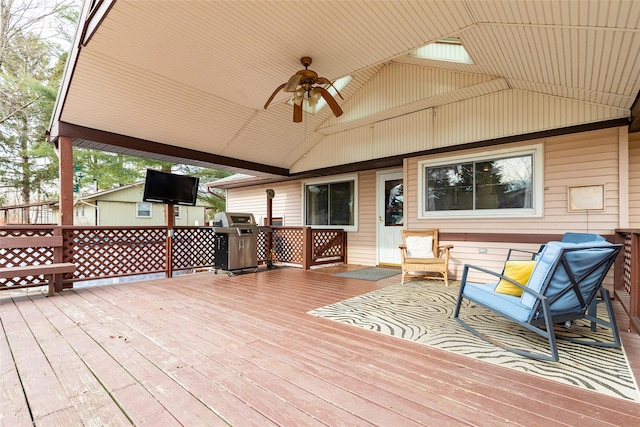 wooden terrace with ceiling fan and a grill