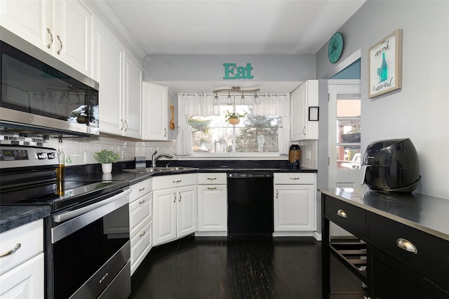 kitchen featuring a wealth of natural light, stainless steel appliances, backsplash, and white cabinetry