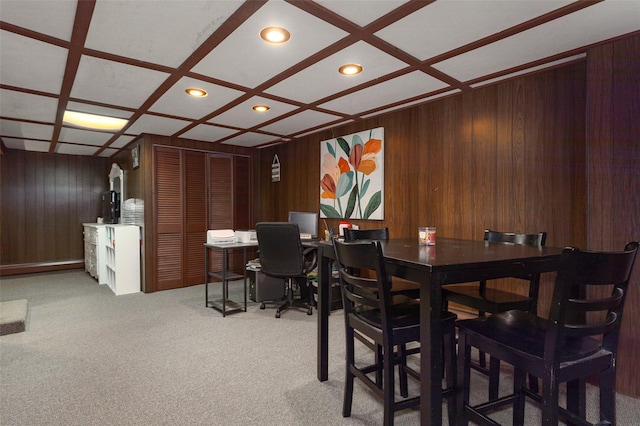 dining space with light colored carpet, beamed ceiling, and coffered ceiling