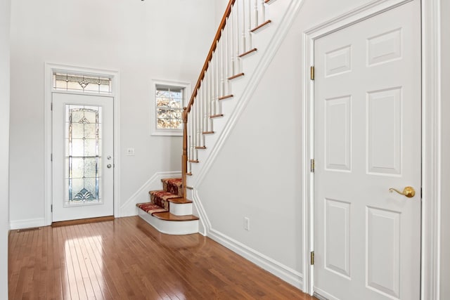 foyer entrance with hardwood / wood-style floors and a healthy amount of sunlight