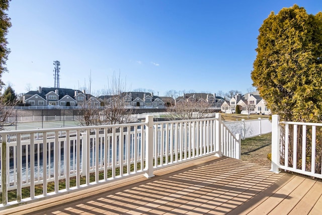 deck featuring tennis court