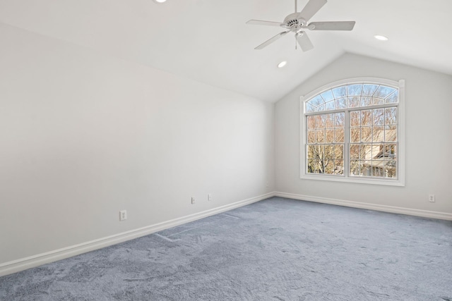 empty room featuring ceiling fan, carpet flooring, and vaulted ceiling