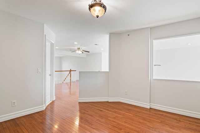 unfurnished room with light wood-type flooring and ceiling fan