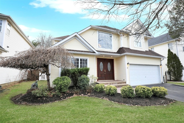 front of property featuring a front yard and a garage