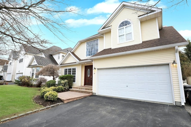 view of front property featuring a front lawn and a garage