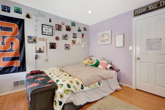 bedroom with wood-type flooring