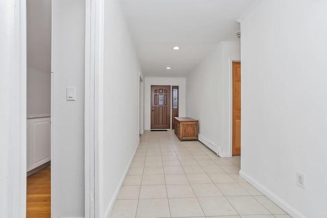 corridor featuring light tile patterned floors and baseboard heating