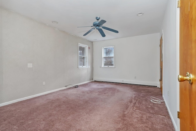 carpeted spare room with a baseboard radiator and ceiling fan