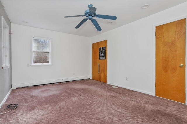 spare room featuring a baseboard radiator, carpet floors, and ceiling fan