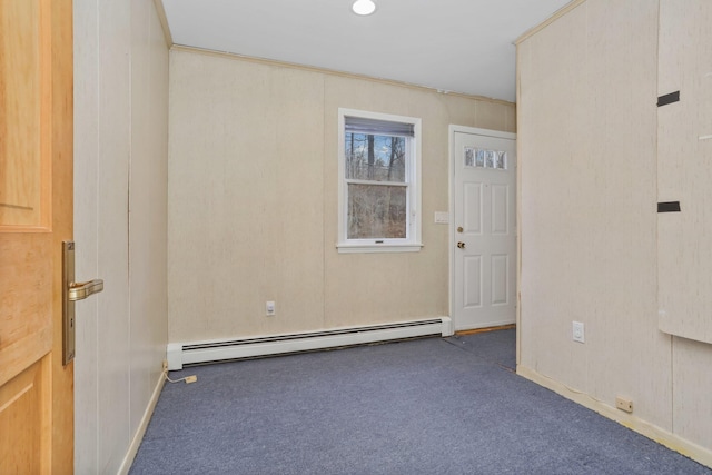 carpeted spare room featuring baseboard heating