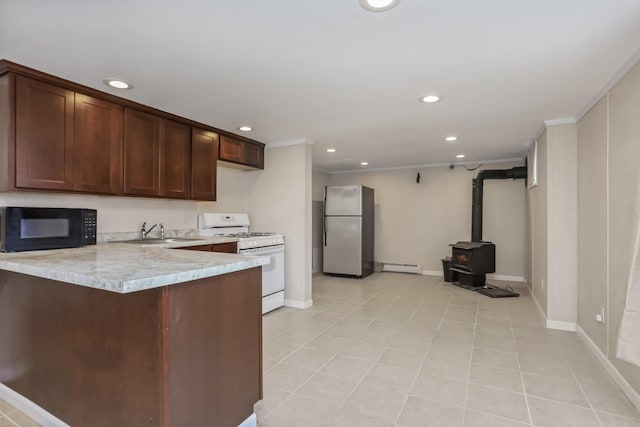 kitchen with sink, white range with gas stovetop, a baseboard radiator, stainless steel fridge, and kitchen peninsula