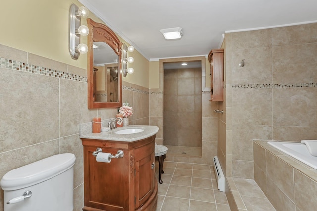 full bathroom with crown molding, tile walls, a baseboard heating unit, vanity, and tile patterned floors