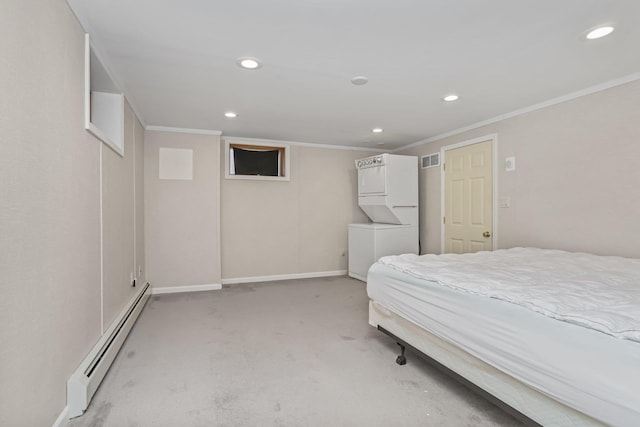 carpeted bedroom with crown molding, stacked washer / drying machine, and a baseboard heating unit