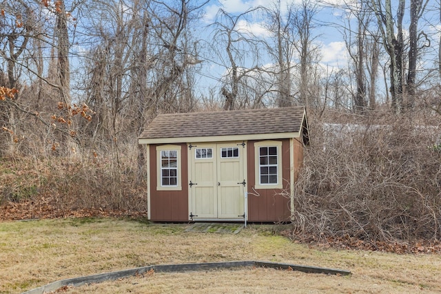 view of outdoor structure with a lawn