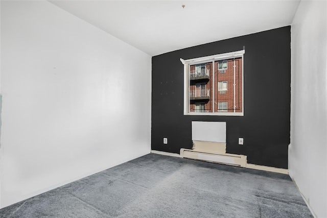 empty room with carpet floors and a baseboard radiator