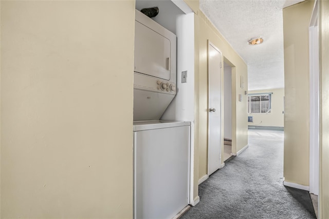 laundry room with light carpet, stacked washer and dryer, and a textured ceiling