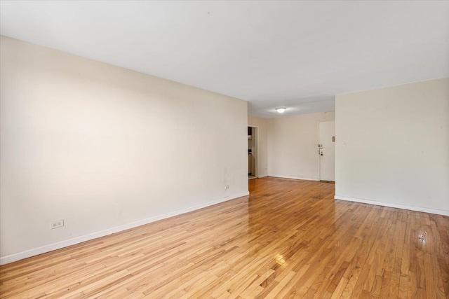 unfurnished room with light hardwood / wood-style floors