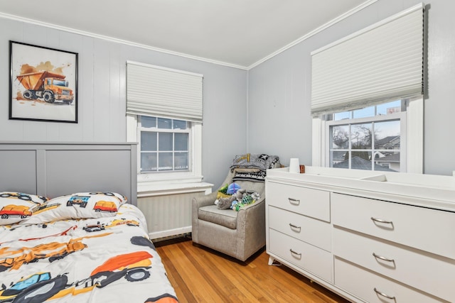 bedroom featuring light hardwood / wood-style flooring and crown molding