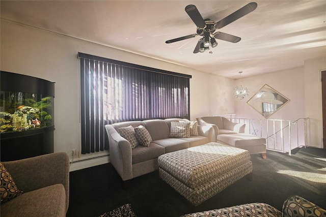 carpeted living room featuring a baseboard heating unit and ceiling fan with notable chandelier