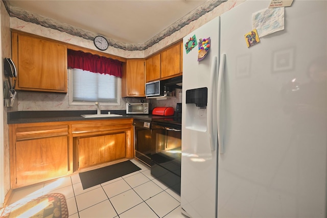 kitchen featuring white fridge with ice dispenser, black dishwasher, sink, light tile patterned flooring, and stove