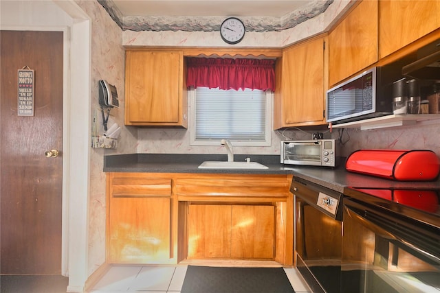 kitchen with sink, light tile patterned floors, dishwasher, and stove