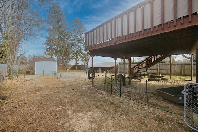 view of yard with a wooden deck and a shed