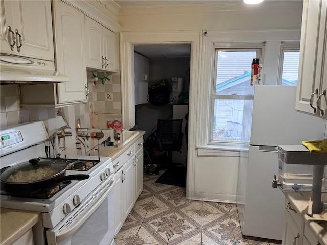 kitchen with white cabinetry, white appliances, and decorative backsplash