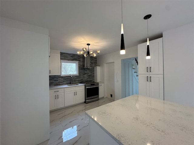 kitchen with stainless steel range with gas cooktop, marble finish floor, backsplash, white cabinetry, and a sink