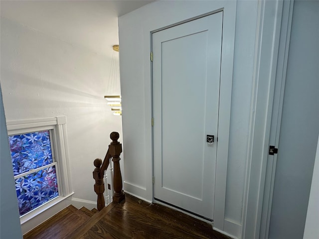 interior space featuring dark wood finished floors and baseboards