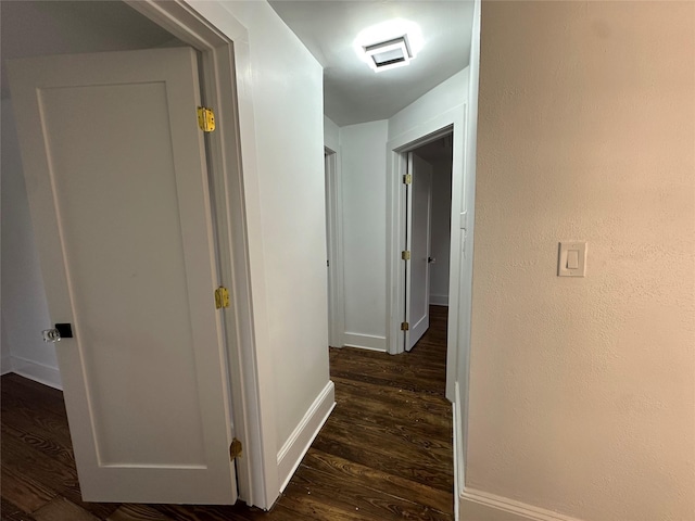 corridor featuring dark hardwood / wood-style flooring