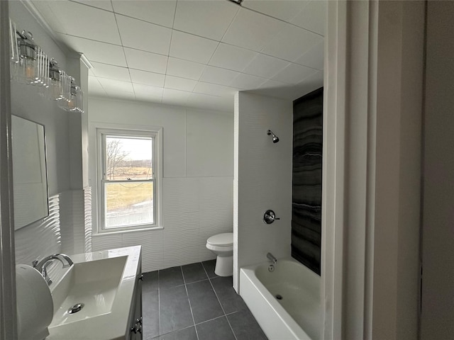 bathroom featuring washtub / shower combination, vanity, toilet, and tile patterned floors