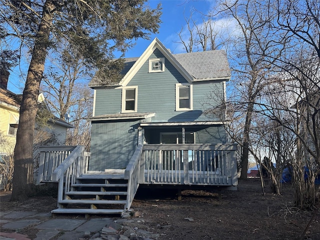 rear view of property featuring a deck