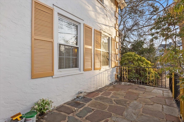 view of side of home with a patio area