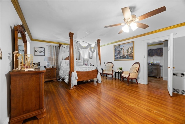 bedroom with radiator, crown molding, and dark hardwood / wood-style floors