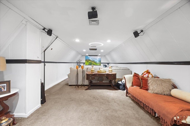 sitting room with carpet floors and vaulted ceiling