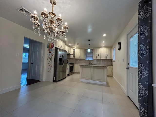 kitchen featuring a kitchen island, stainless steel appliances, decorative backsplash, hanging light fixtures, and a chandelier