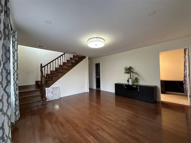 unfurnished living room featuring dark hardwood / wood-style floors