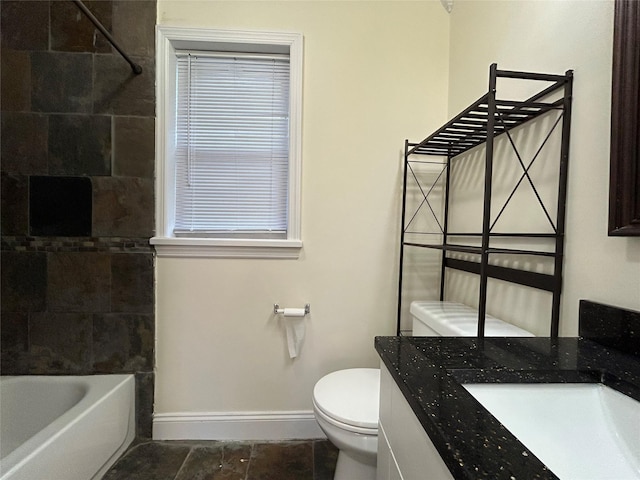 full bathroom with tiled shower / bath, vanity, and toilet