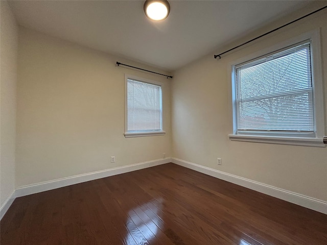 spare room featuring dark hardwood / wood-style flooring