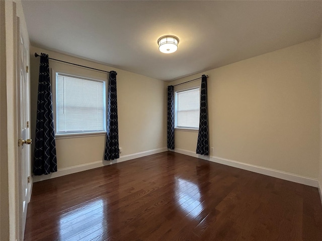 spare room with dark wood-type flooring