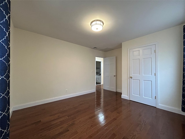 unfurnished bedroom featuring dark wood-type flooring