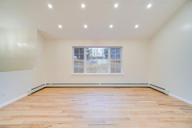 spare room with light hardwood / wood-style floors and baseboard heating