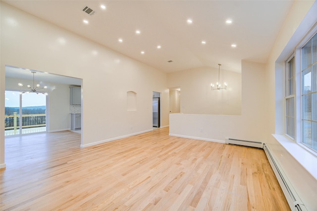 spare room with light hardwood / wood-style floors, vaulted ceiling, a chandelier, and a baseboard radiator