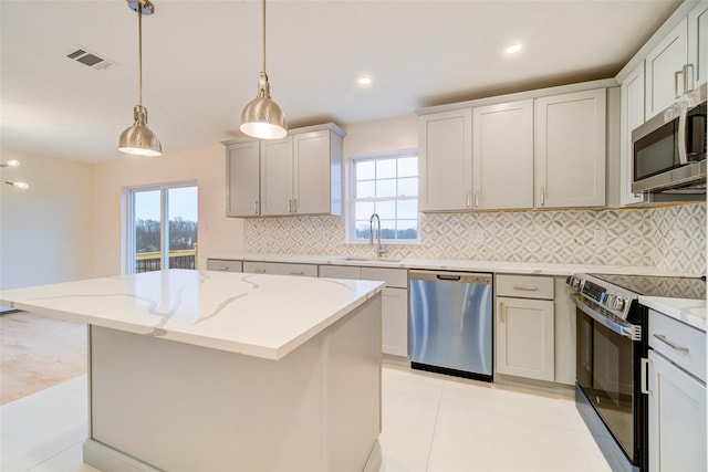 kitchen featuring sink, a center island, and stainless steel appliances