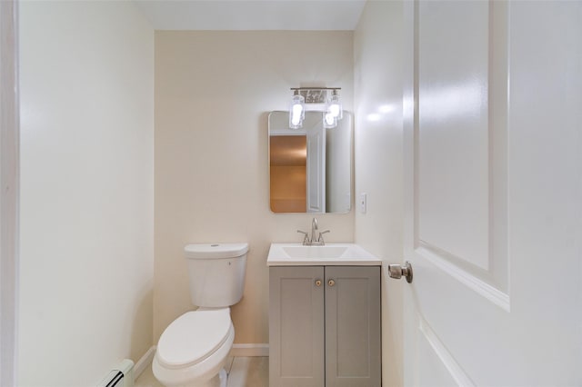 bathroom featuring toilet, vanity, baseboard heating, and tile patterned flooring