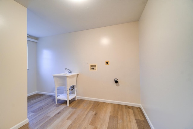 laundry area with light hardwood / wood-style floors, washer hookup, and electric dryer hookup