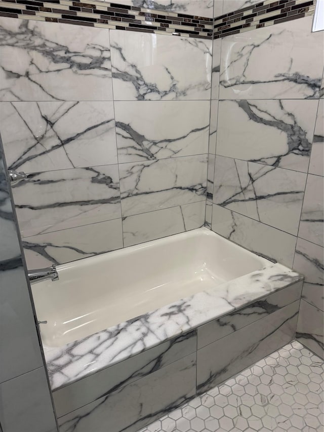 bathroom with tile patterned flooring and tub / shower combination