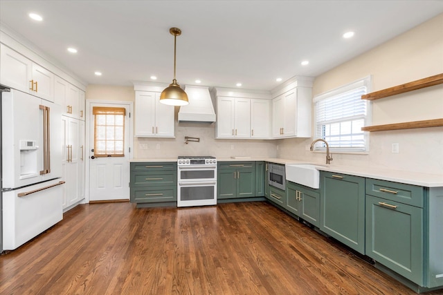 kitchen featuring sink, white cabinetry, green cabinetry, custom range hood, and stainless steel appliances