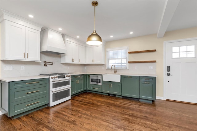 kitchen with premium range hood, sink, white cabinets, range with two ovens, and green cabinets